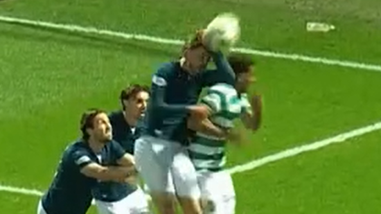 Screengrab of the moment Motherwell's Sam Nicholson challenges for a high ball against Celtic, with his left arm raised as he looks to head away