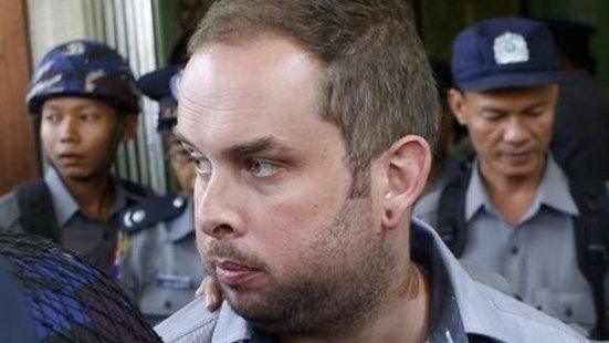 New Zealand citizen Philip Blackwood is escorted by policemen after a hearing at a court, Yangon, Myanmar