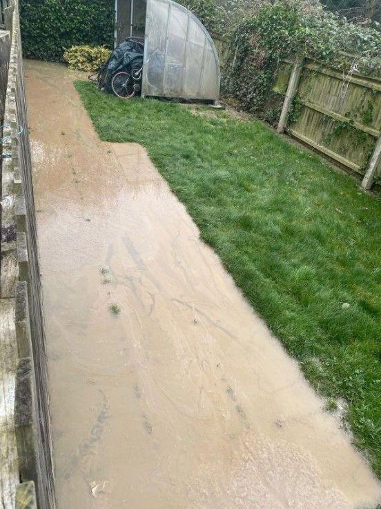 A path near a bicycle store which has been flooded with raw sewage