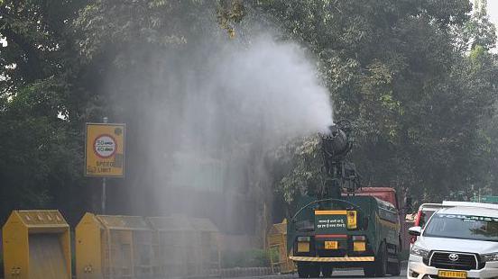 An Anti Smog Truck seen sprinkling water over the street to settle down dust particles amid pollution at Raisina Road on October 27, 2024 in New Delhi, India. 