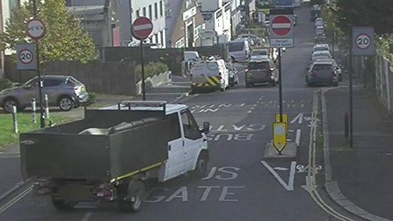 CCTV image of a tipper truck driving through a no entry road