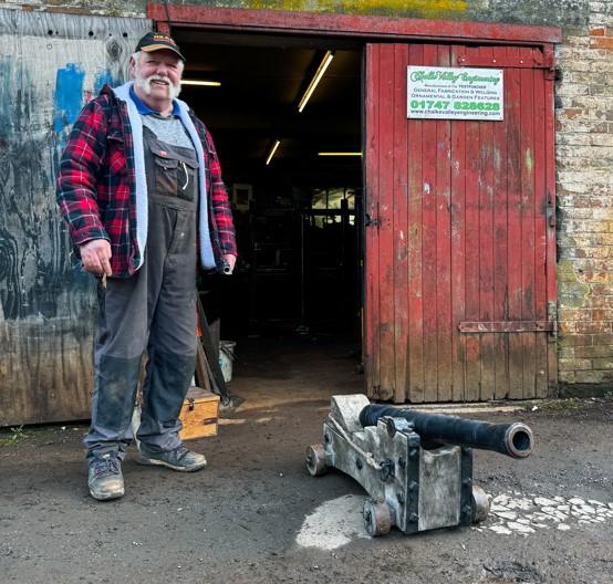 Mr Mead and a cannon outside his workshop