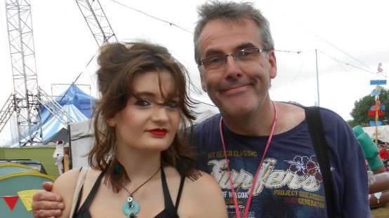 A young woman with a man at a music festival
