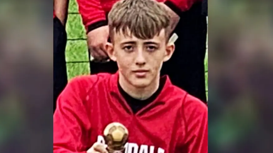 Harry Parker holding a trophy, looking at the camera