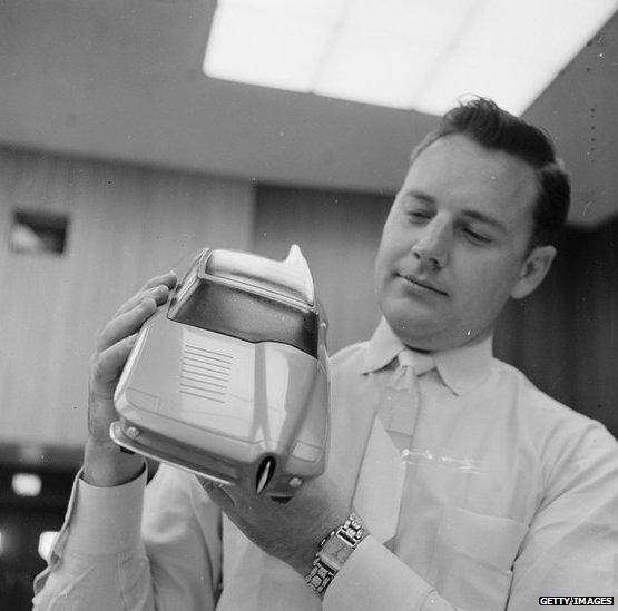 An employee at General Motors in Detroit shows a prototype of a car in 1955