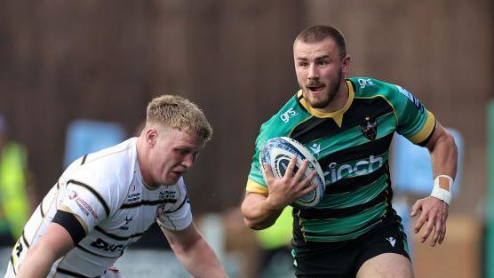 Northampton's Ollie Sleightholme runs with the ball on the way to scoring a try