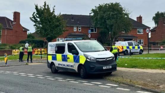 Police cordon and vehicles