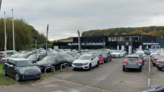 Cars outside a showroom that Aldi wants to demolish