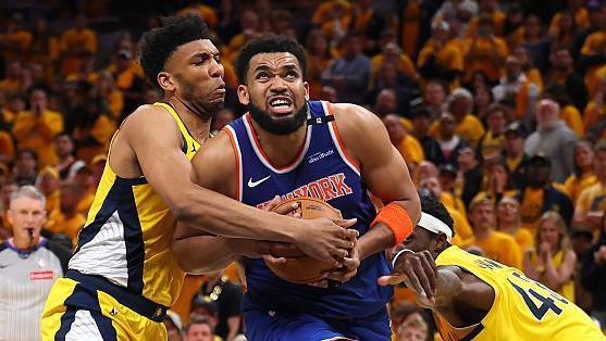 Karl-Anthony Towns tries to escape the clutches of an opponent