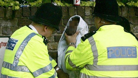 File photo dated 28/8/2008 of police officers searching a man heading for the Notting Hill Carnival, London