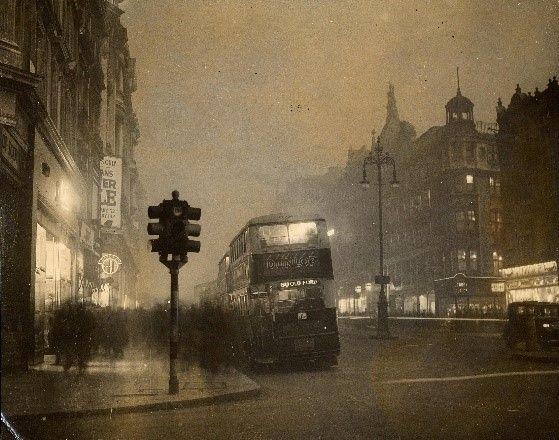 Black and white bus on Oxford Street at twilight, by Topical Press, 1935. 