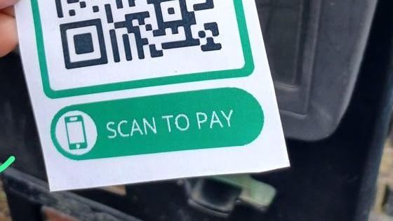 QR code with a green box reading 'scan to pay' underneath it