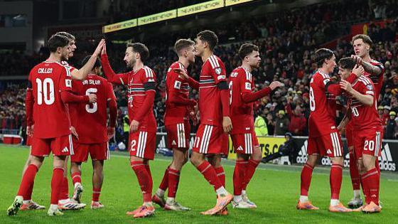 Wales players celebrate Dan James' goal
