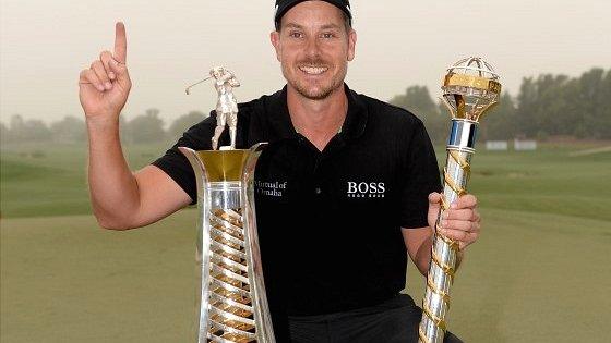 Henrik Stenson with the World Tour Championship and Race to Dubai trophies