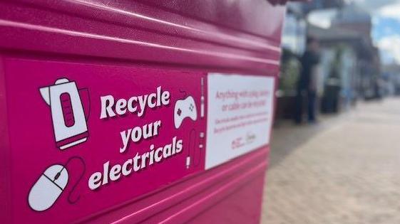 Pink recycling bin on a high street