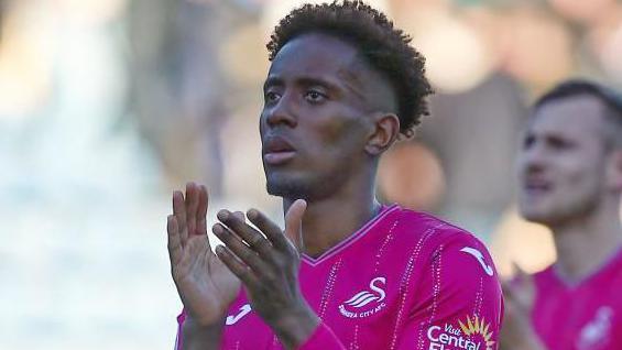 Jamal Lowe applauds whilst playing for Swansea City