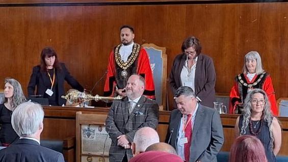 Imtiyaz Shaikh taking up the chains of office in the council chamber