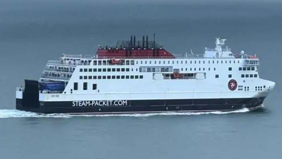 A closeup of the Manxman a large, tall, white ferry which reads steam packet as it sails.