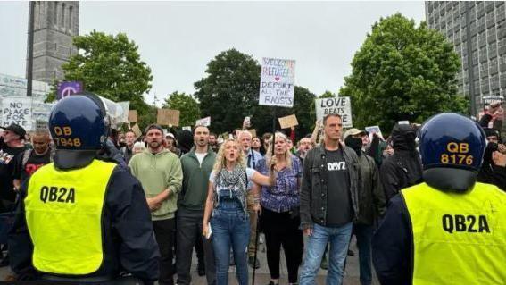 Plymouth city centre protests with anti-racism campaigners facing a line of police