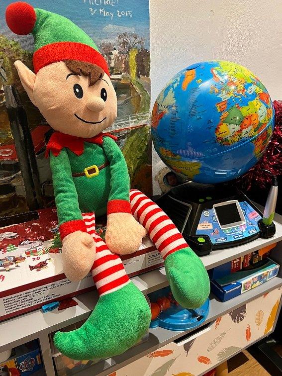 Elf sitting on an advent calendar