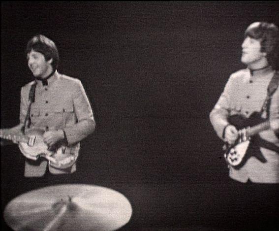 Screenshot of Paul McCartney and John Lennon playing guitars and singing