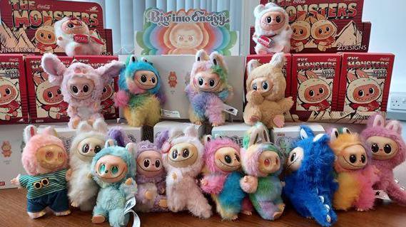 An aray of colourful fake Labubu dolls are pictured together with their boxes after being seized