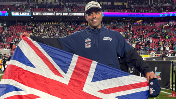 Aden Durde holding a British flag after winning Super Bowl 60