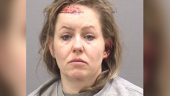 A mugshot of Roe with a scraped head and ear looking into the camera