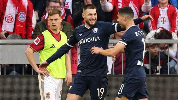 Matus Bero of Bochum celebrates scoring his team's third goal with team-mate Giorgos Masouras 