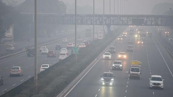  A cyclist use foot-over-bridge to cross the road amid cold and foggy weather at NH-48 near Iffco chowk elevated u-turn, on January 9, 2025 in Gurugram, India.