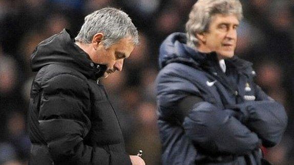 Manchester City manager Manuel Pellegrini stands beyond Chelsea manager Jose Mourinho (left)