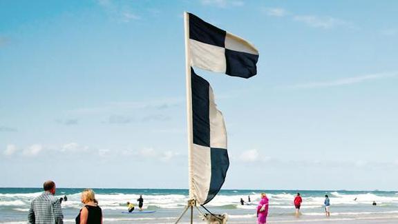 A black and white chequered flag on the beach