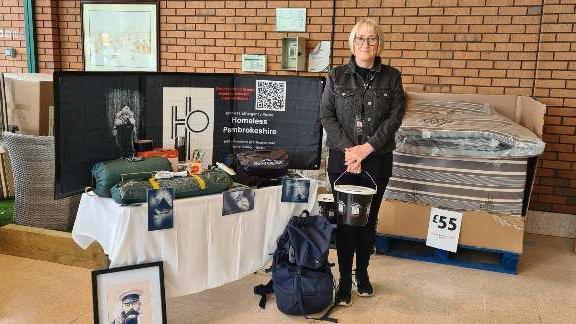 Amanda Evans holding a donation bucket