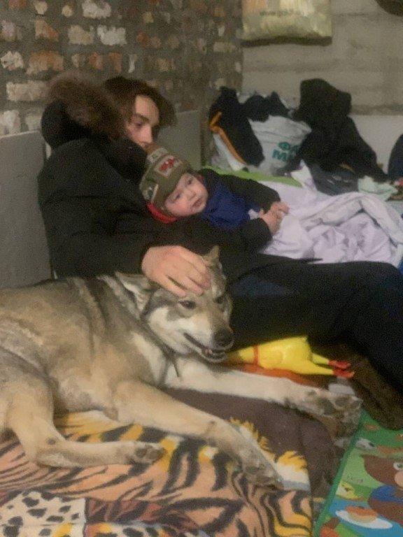 Yaroslav Kryvoshyia (left) sheltering in a bunker in Ukraine with his brother (name not given) and their family dog