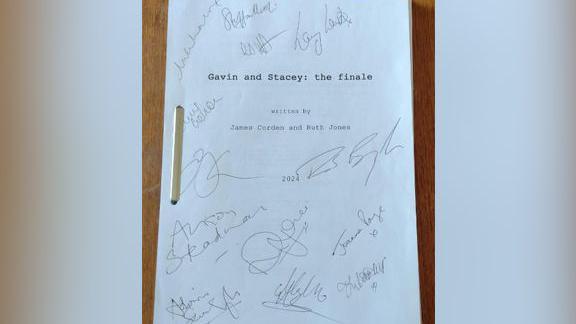 A original Gavin and Stacey script with all of the main casts signatures on it. 
The cover says Gavin and Stacey: the finale. Written by James Corden and Ruth Jones.