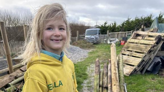 Ella, outdoors, around wood