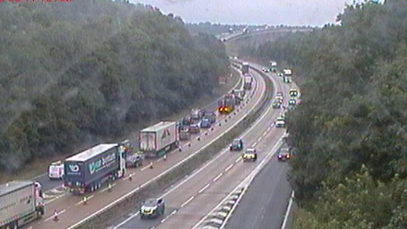 A traffic camera image of the A14 leading toward the A14. Long queues of traffic can be seen on the left hand carriageway.