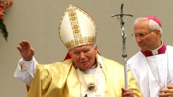 Pope John Paul II blesses the pilgrims during the Holy mass celebrated at the Chaika airport, outside Kiev, Sunday, June 24, 2001