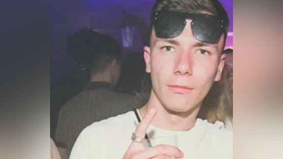 Ben Bland pictured at a night club. He is wearing sunglasses on his head and wearing a cream top.