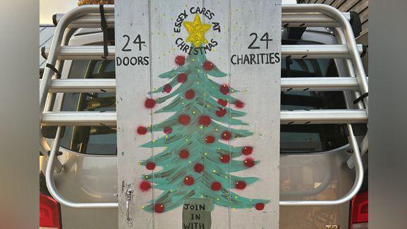 Image of a christmas tree with 24 doors and 24 charities written on either side of it.