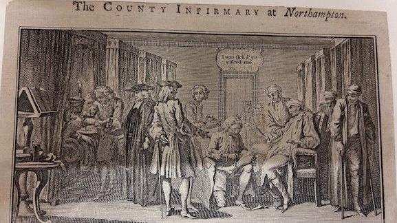 An old image of The County of Northampton Infirmary. The drawing shows various patients inside a room wearing bandages and receiving medical care. 