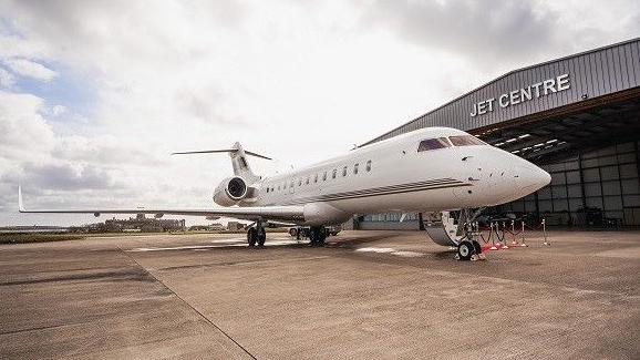 Jet parked next to private terminal