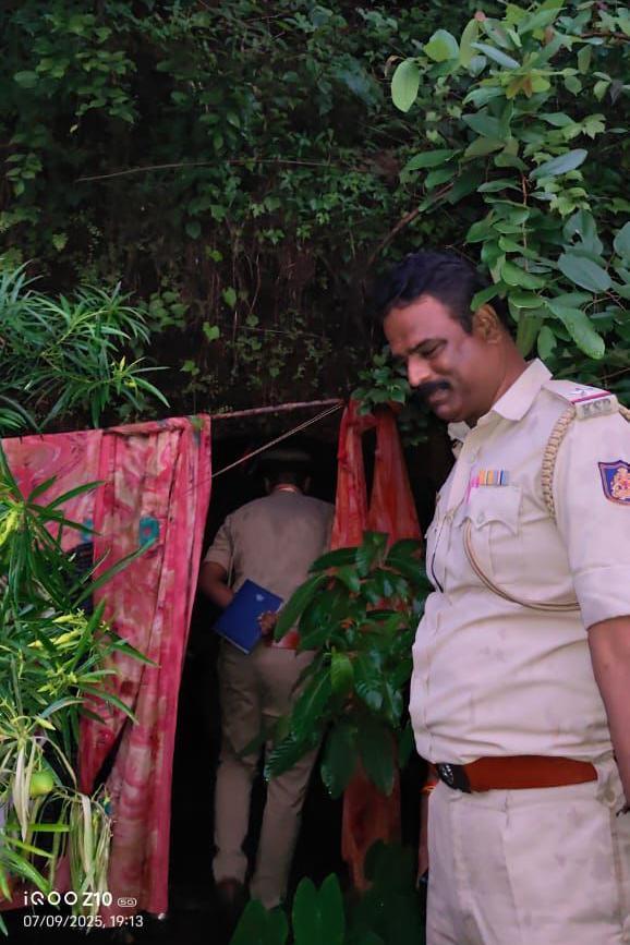 Policemen stand outside the cave in Gokarna forest