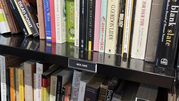 A number of the books donated by Nick Cave, on display at the Oxfam book shop in Hove, East Sussex.
