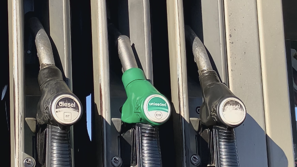 Three petrol pumps on a garage forecourt 
