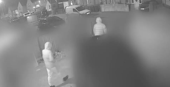 CCTV image of Max and Mason leaving a house, with both wearing hooded coats. 