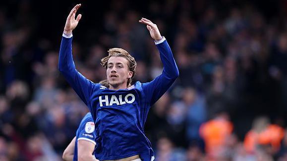 Ipswich's Jack Clarke jumps in the air with both arms raised after scoring the equaliser against Middlesbrough
