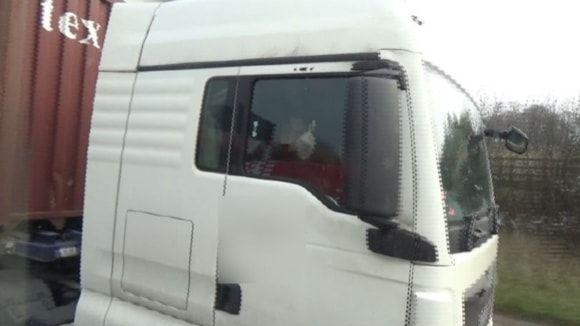 A HGV driver is seen putting up his middle finger while driving.