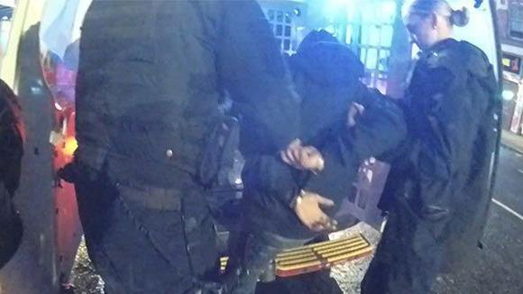 An image of a man being arrested by two police officers in Nottingham