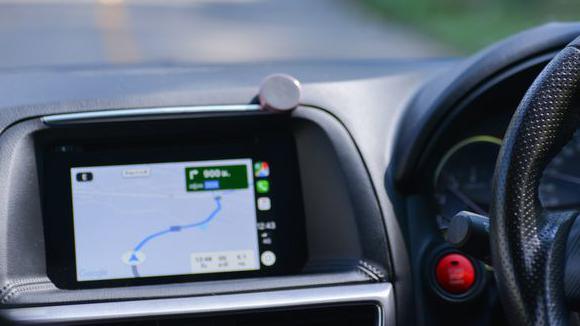 A sat-nav display built into the dashboard of a car. 